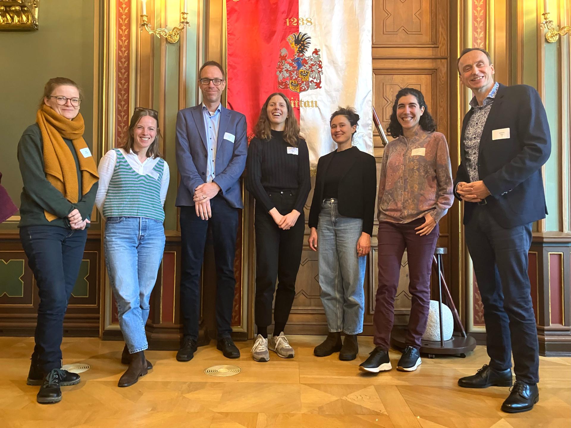 Team Transformationsforschung auf der Konferenz "Transformationswissen" in Zittau. Eine Gruppe von sieben Personen blickt lächelnd in die Kamera.